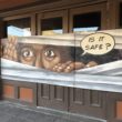 Mural on boarded up storefront