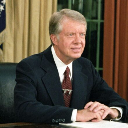 Photo of President Jimmy Carter at his desk in the Oval Office delivering his speech on inflation, October 24, 1978.