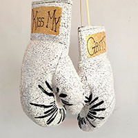 Borrowing from the traditional Vietnamese Sơn mài lacquer painting tradition, MyLoan Dinh delicately transformed a pair of boxing gloves with eggshell. The title, Kiss My Grits, is drawn from a deeply Southern expression of defiance made famous by the character Florence Jean "Flo" Castleberry on the 1970s sitcom Alice.