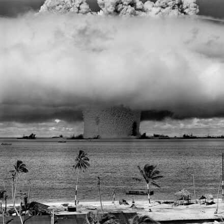 The "Baker" explosion, part of Operation Crossroads, a nuclear weapon test by the United States military at Bikini Atoll, Micronesia, on 25 July 1946. The wider, exterior cloud is actually just a condensation cloud caused by the Wilson chamber effect, and was very brief. The actual mushroom cloud is inside the condensation cloud (compare with this image, a photo taken slightly later, after the condensation cloud had cleared). The water released by the explosion was highly radioactive and contaminated many of the ships that were set up near it. Some were otherwise undamaged and sent to Hunter's Point in San Francisco, California, United States for decontamination. Those which could not be decontaminated were sunk a number of miles off the coast of San Francisco.