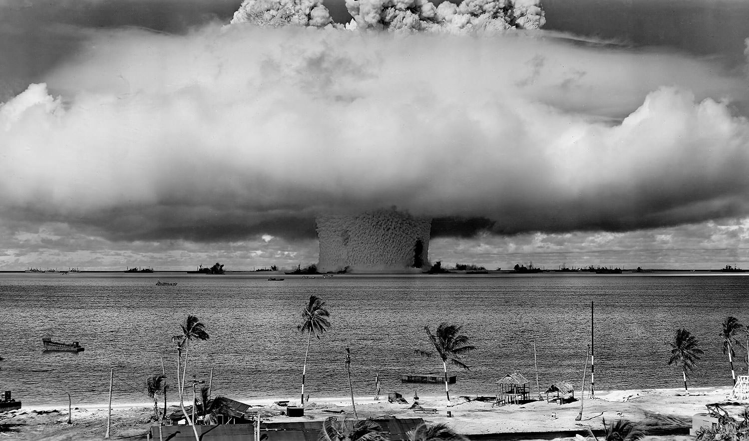 The "Baker" explosion, part of Operation Crossroads, a nuclear weapon test by the United States military at Bikini Atoll, Micronesia, on 25 July 1946. The wider, exterior cloud is actually just a condensation cloud caused by the Wilson chamber effect, and was very brief. The actual mushroom cloud is inside the condensation cloud (compare with this image, a photo taken slightly later, after the condensation cloud had cleared). The water released by the explosion was highly radioactive and contaminated many of the ships that were set up near it. Some were otherwise undamaged and sent to Hunter's Point in San Francisco, California, United States for decontamination. Those which could not be decontaminated were sunk a number of miles off the coast of San Francisco.