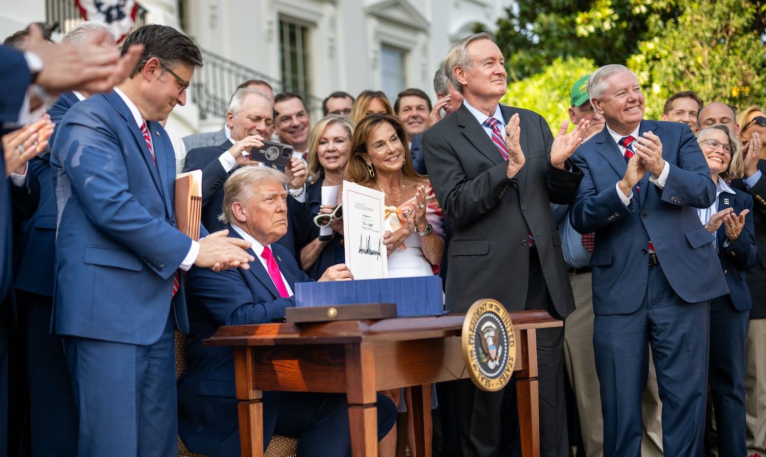 President Donald Trump signs the One Big Beautiful Bill Act on the South Lawn of the White House, Friday, July 4, 2025, during the 4th of July picnic. (Official White House Photo by Daniel Torok)
