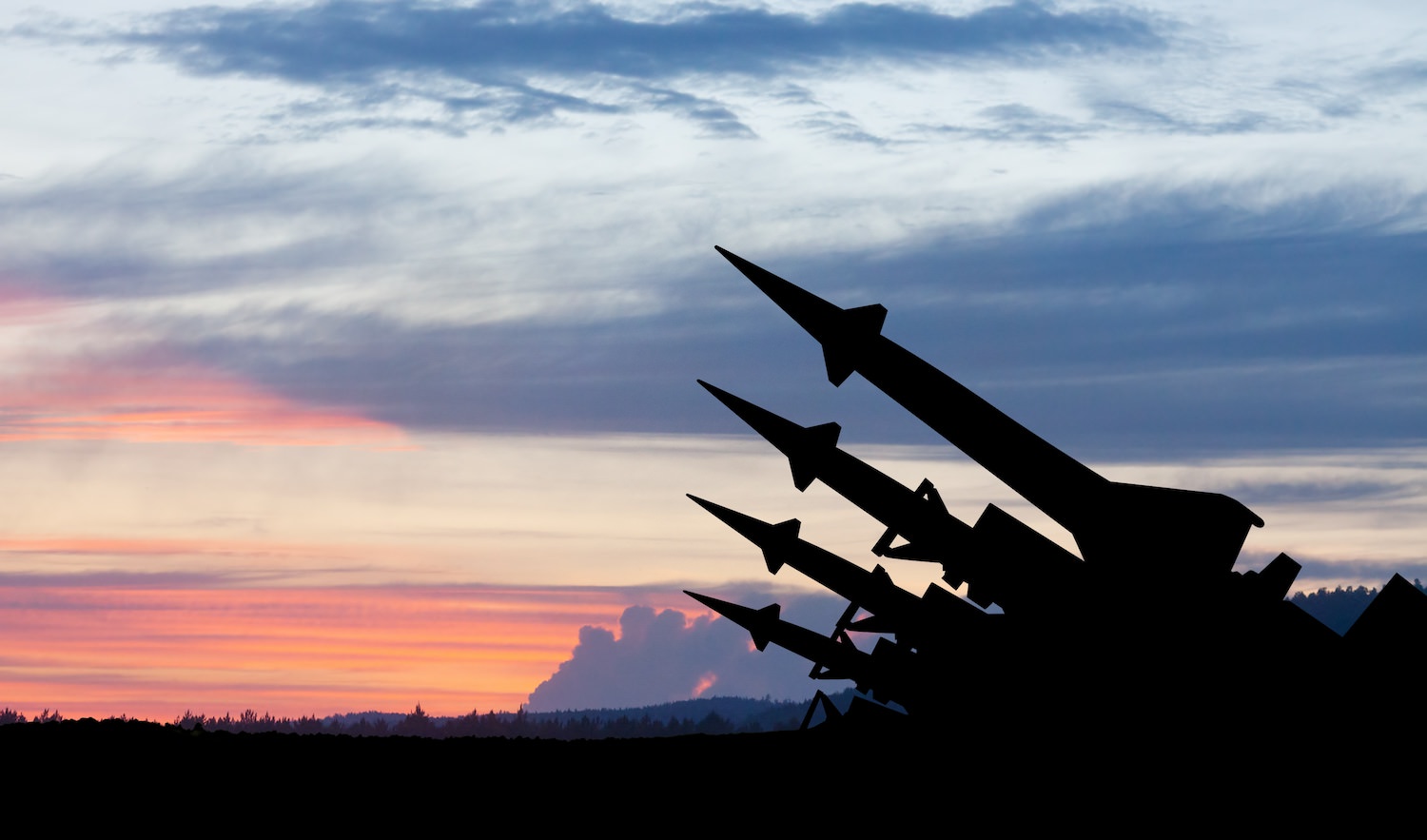 The missiles are aimed to the sky at sunset.