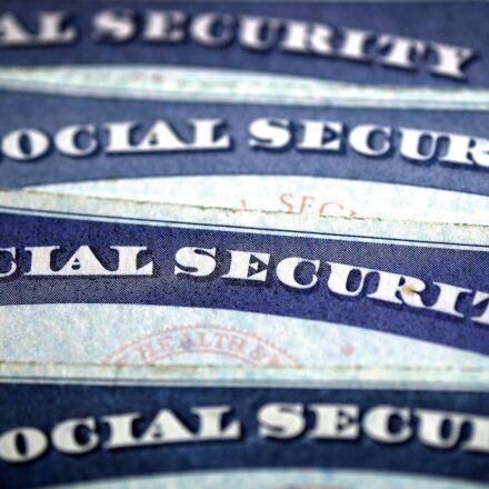 Closeup of a pile of Social Security cards.